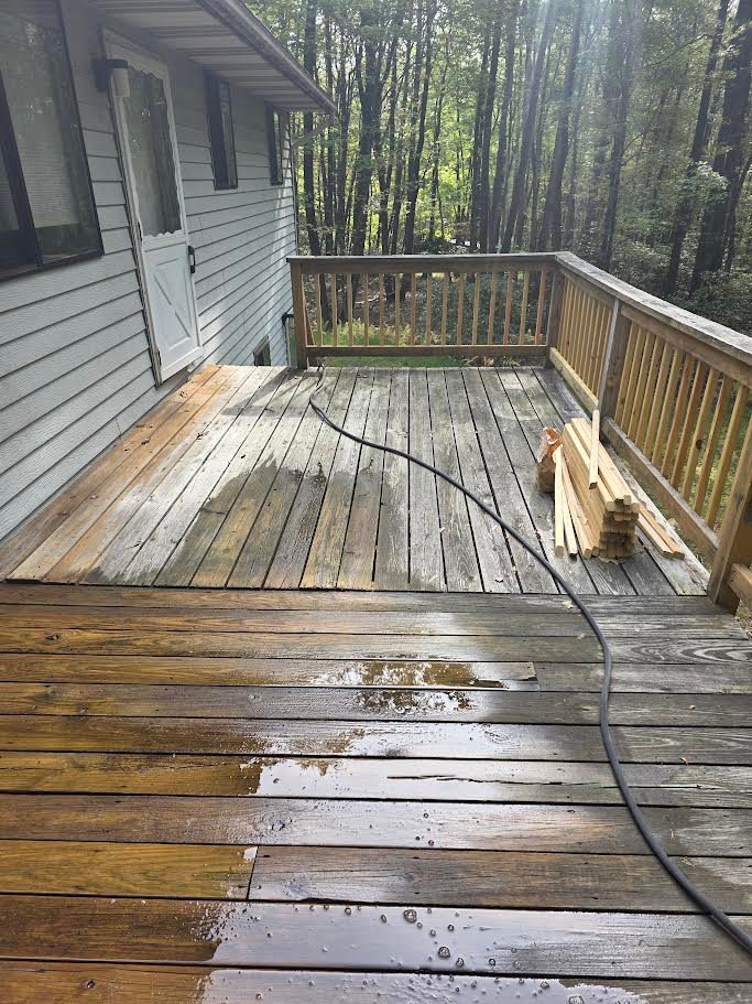 Power washing a wood deck in progress