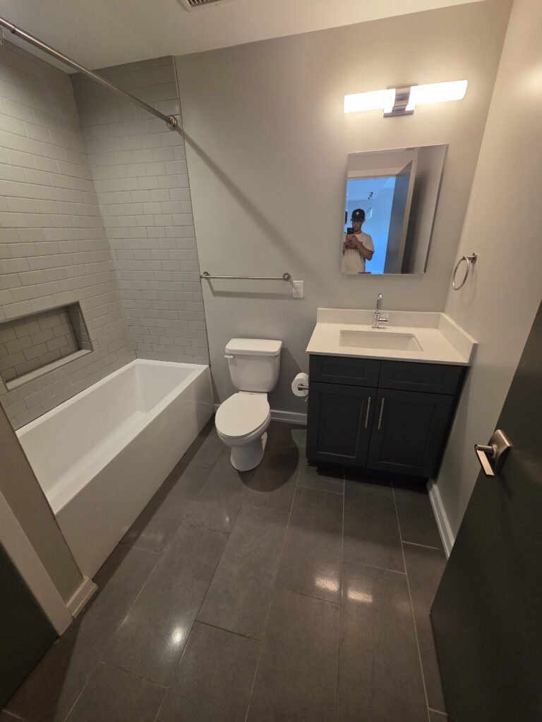 Finished bathroom with tub and vanity